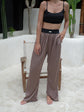 Silk trousers in a refined shade of deep taupe